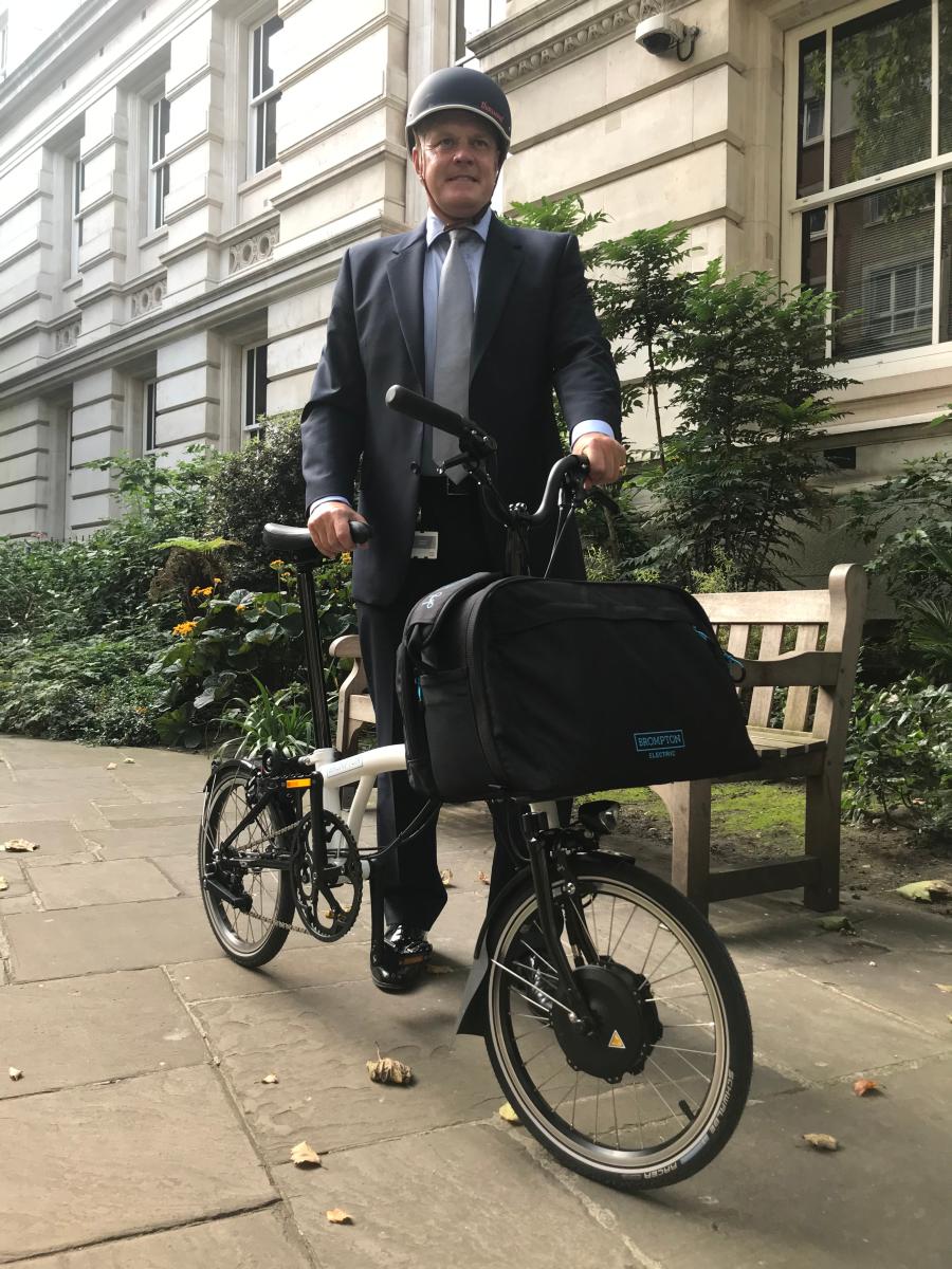 Professor Charles Knight cycling to work on Brompton e-bike