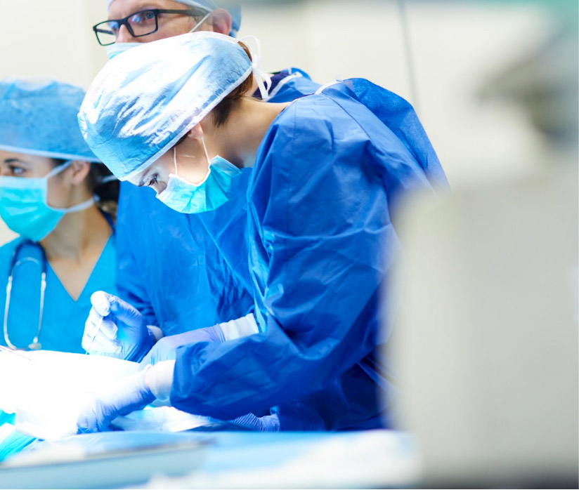 Consultant in theatre operating on a patient