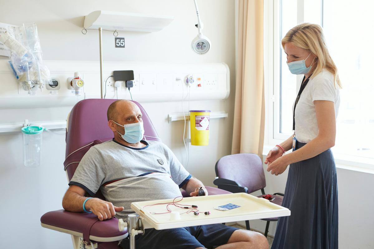 Chemotherapy patient talks to a female staff member