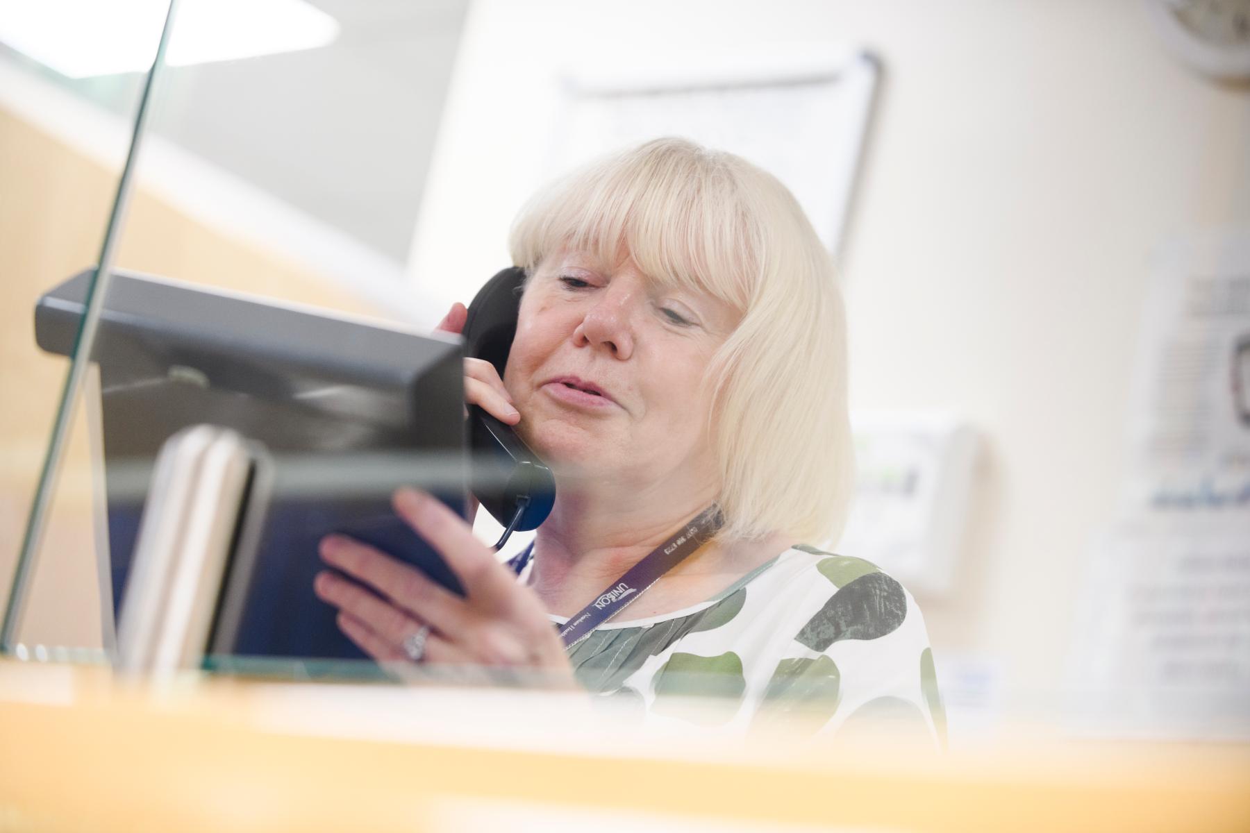 A female receptionist speaking on the phone