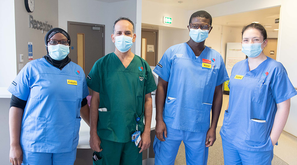Four members of hospital staff with masks on
