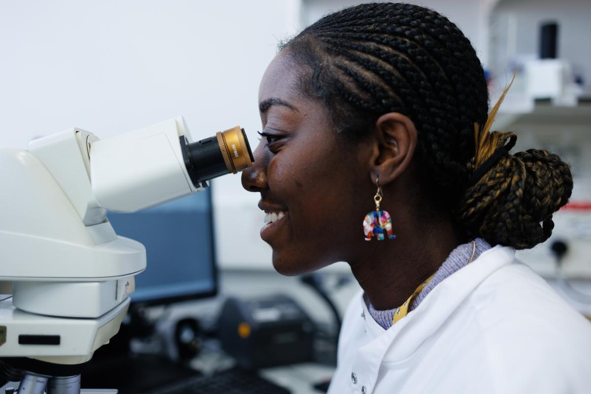 Staff member looking in a microscope