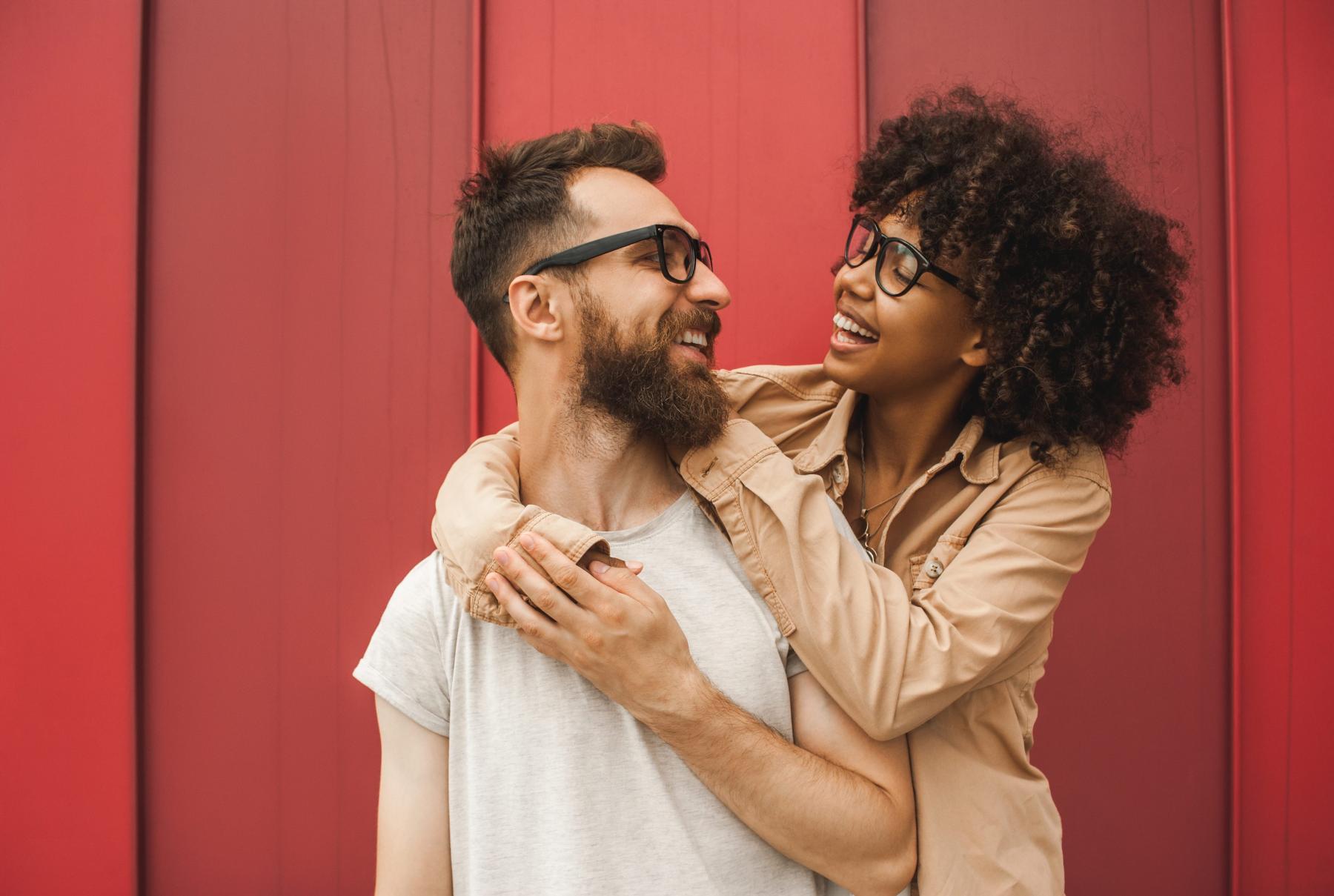 Mixed race couple on red background